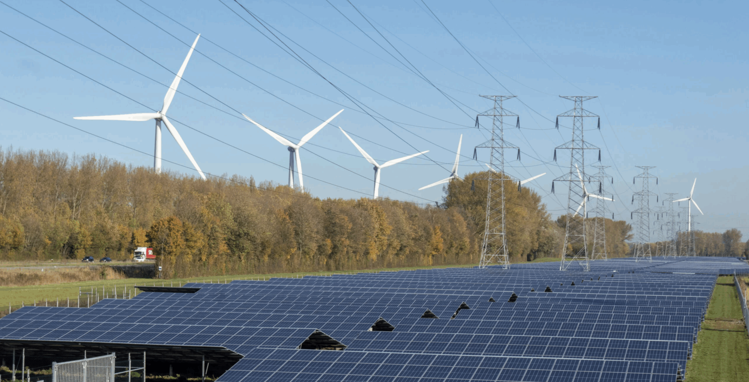 Landscape featuring wind, solar, and transmission lines