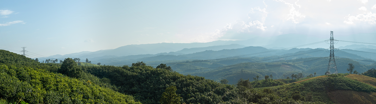Transmission lines surrounded by mountainous landscape.
