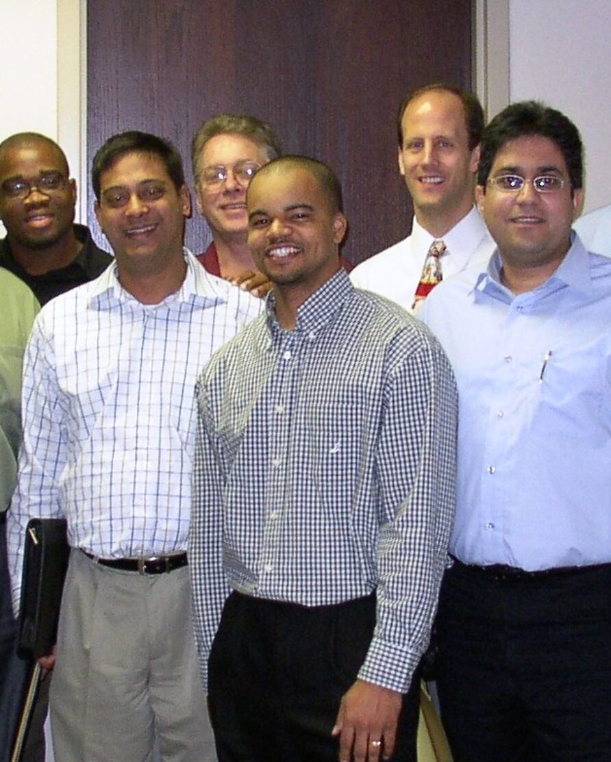 Group of Quanta Technology employees in professional attire in 2010.