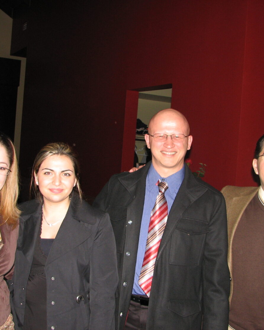 Four employees in business professional attire at a company social event in 2007.