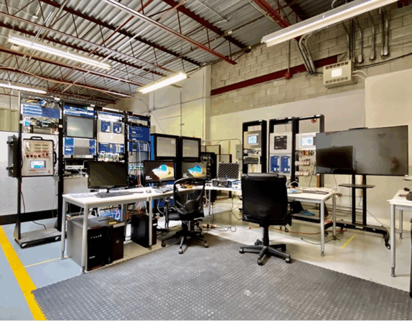 Protection and control laboratory with relay panels, SCADA workstations, and testing equipment used for substation commissioning.