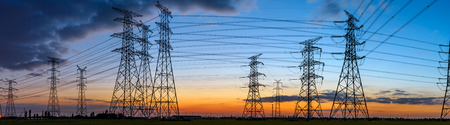 Transmission lines in front of sunset