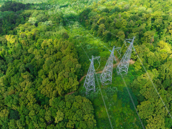 Aerial view. High voltage metal post. High-voltage towers in the forest.