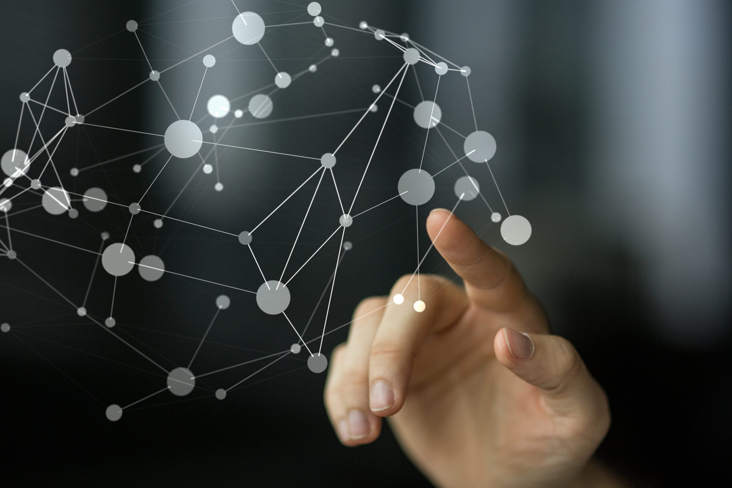 Finger touching an interconnected system.