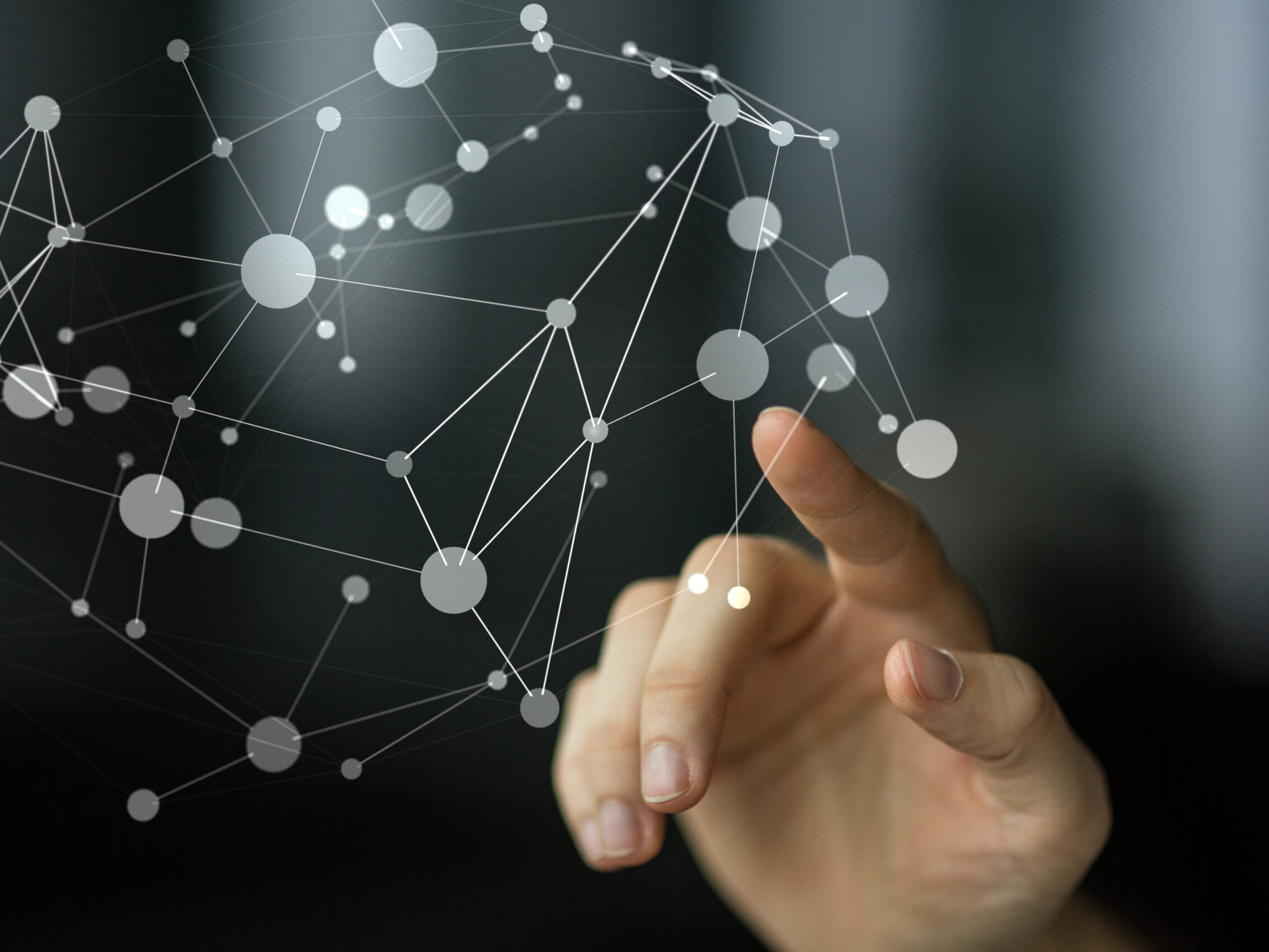 Finger touching an interconnected system.