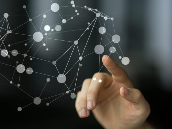 Finger touching an interconnected system.