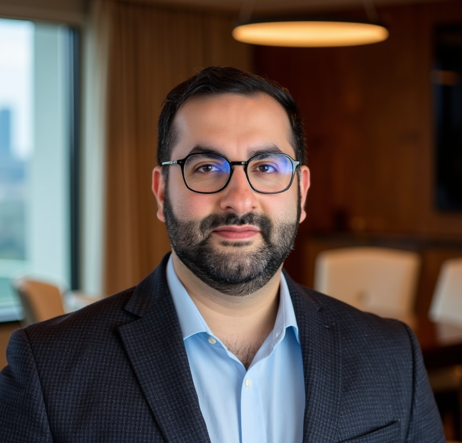 Employee headshot with office background.