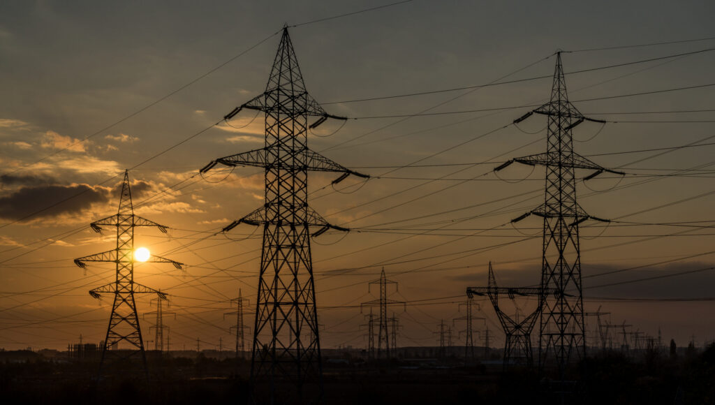 Power lines at sunset for 1996 western blackouts news article.